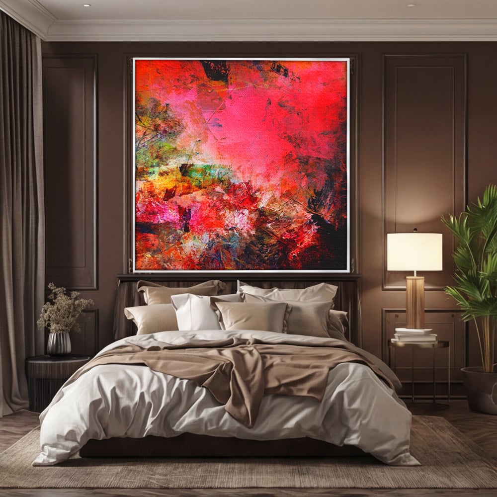 Tablou canvas cu pictura abstracta in nuante de rosu, in rama de aluminiu argintiu, pe perete intr-un dormitor